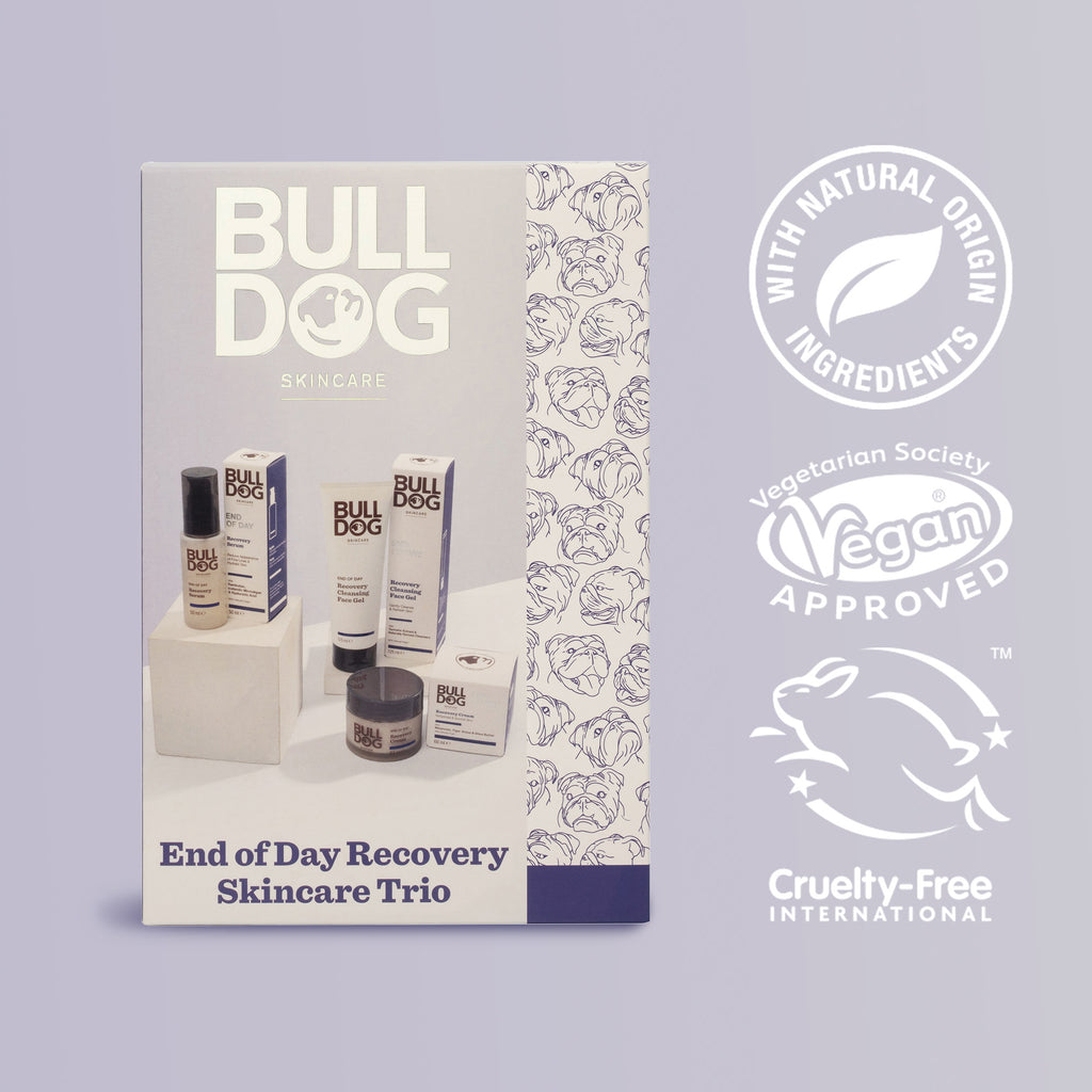 A box of the End of Day Recovery Trio, an ideal skincare gift for him, is displayed next to logos for natural origin ingredients, Vegan Society approval, and Cruelty-Free International certification on a light purple background.