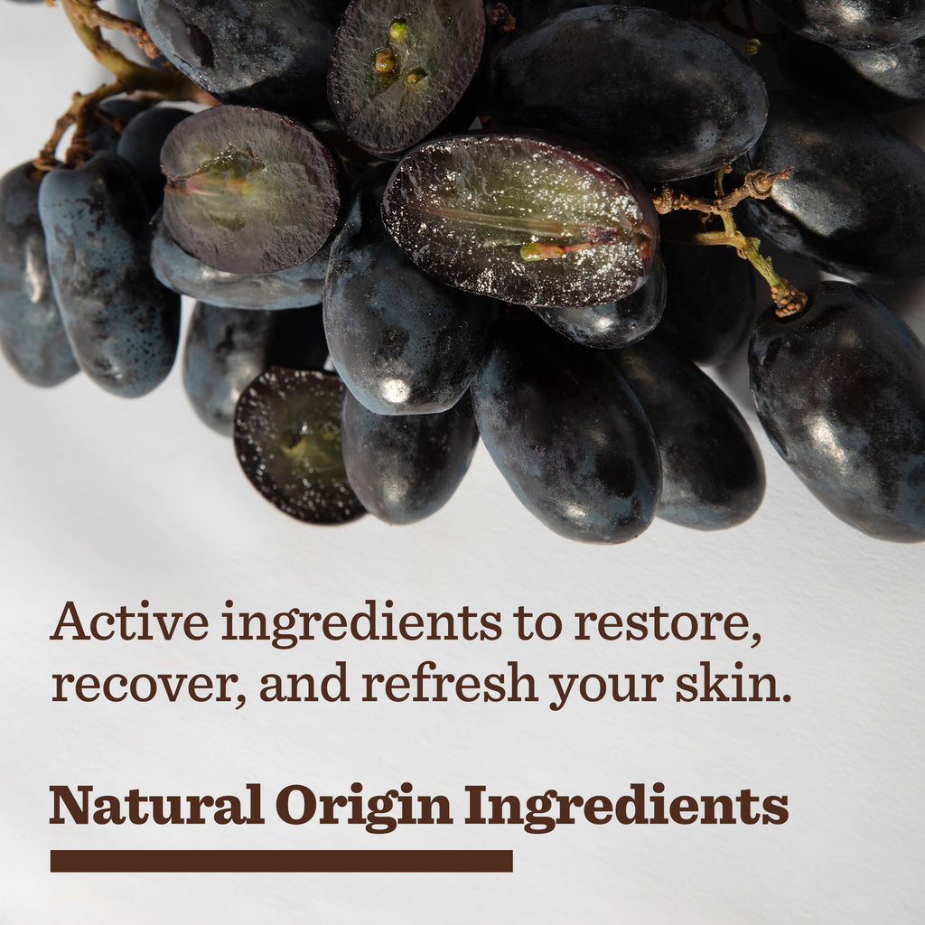 A close-up of dark purple grapes, one sliced open, beside text: Restore, recover, and refresh your skin. Experience our End of Day Recovery Trio with natural origin ingredients.