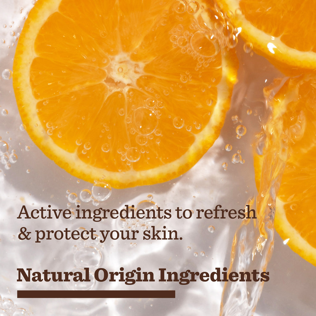 Close-up of fresh orange slices with water splashing, overlaid with text: Advanced Anytime Daily Duo—skincare for men with natural origin ingredients to refresh and protect your skin every day.