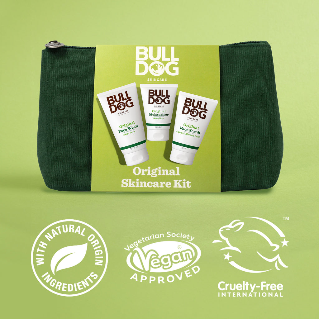 A green toiletry bag featuring the Original Skincare Kit—perfect as a men’s gift—with labels and icons for natural origin ingredients, vegan approval, and cruelty-free certification.
