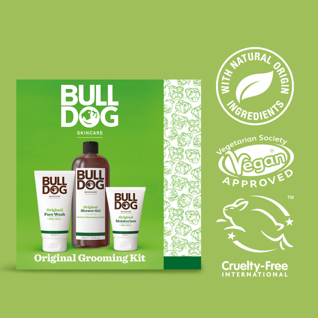The Original Grooming Kit box includes face wash, shaving gel, and moisturizer—perfect for men's grooming. Features logos for natural origin ingredients, vegan approved, and cruelty-free on a green background.