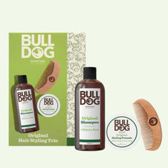 The Hair Styling Trio includes a brown shampoo bottle, a white pomade tub, and a wooden comb in a stylish box—making it the perfect men’s gift set, beautifully arranged on a light background.